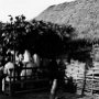 A special festive meal for visiting priests, perhaps on the occasion of a baptism, under a temporary shelter outside the prayer hut.
